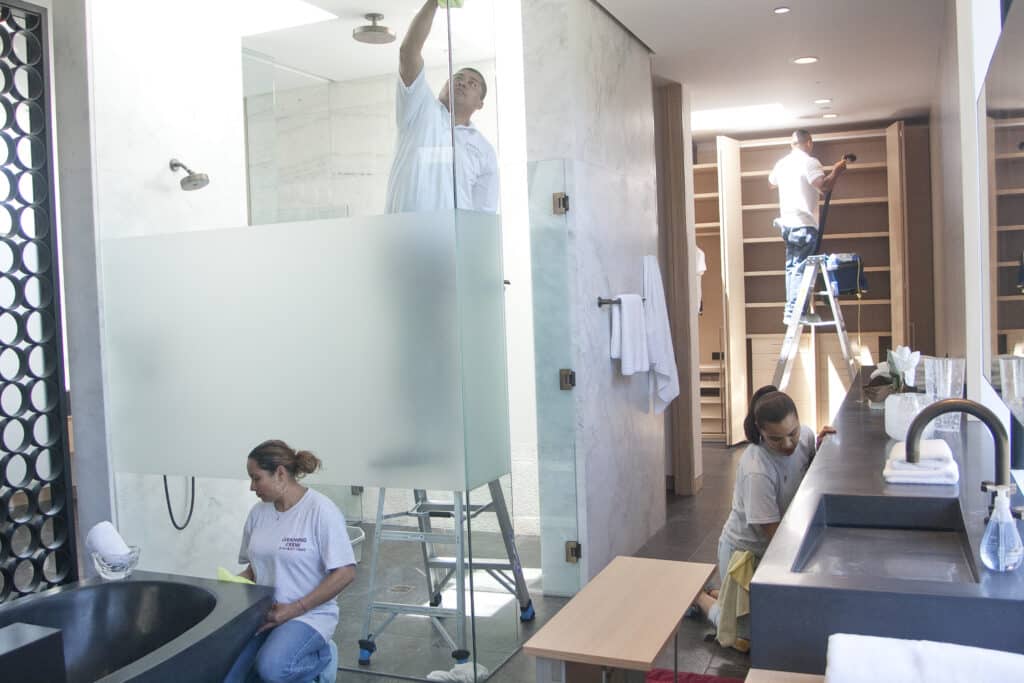 Crew of Cleaners Cleaning a New Bathroom Build after Renovation in Los Angeles, California